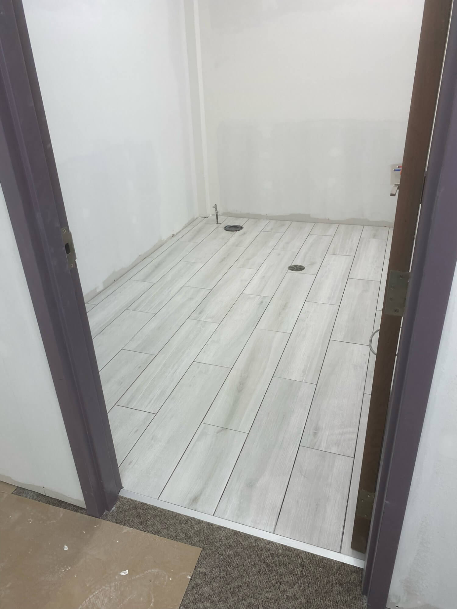Washroom tile floor through doorway