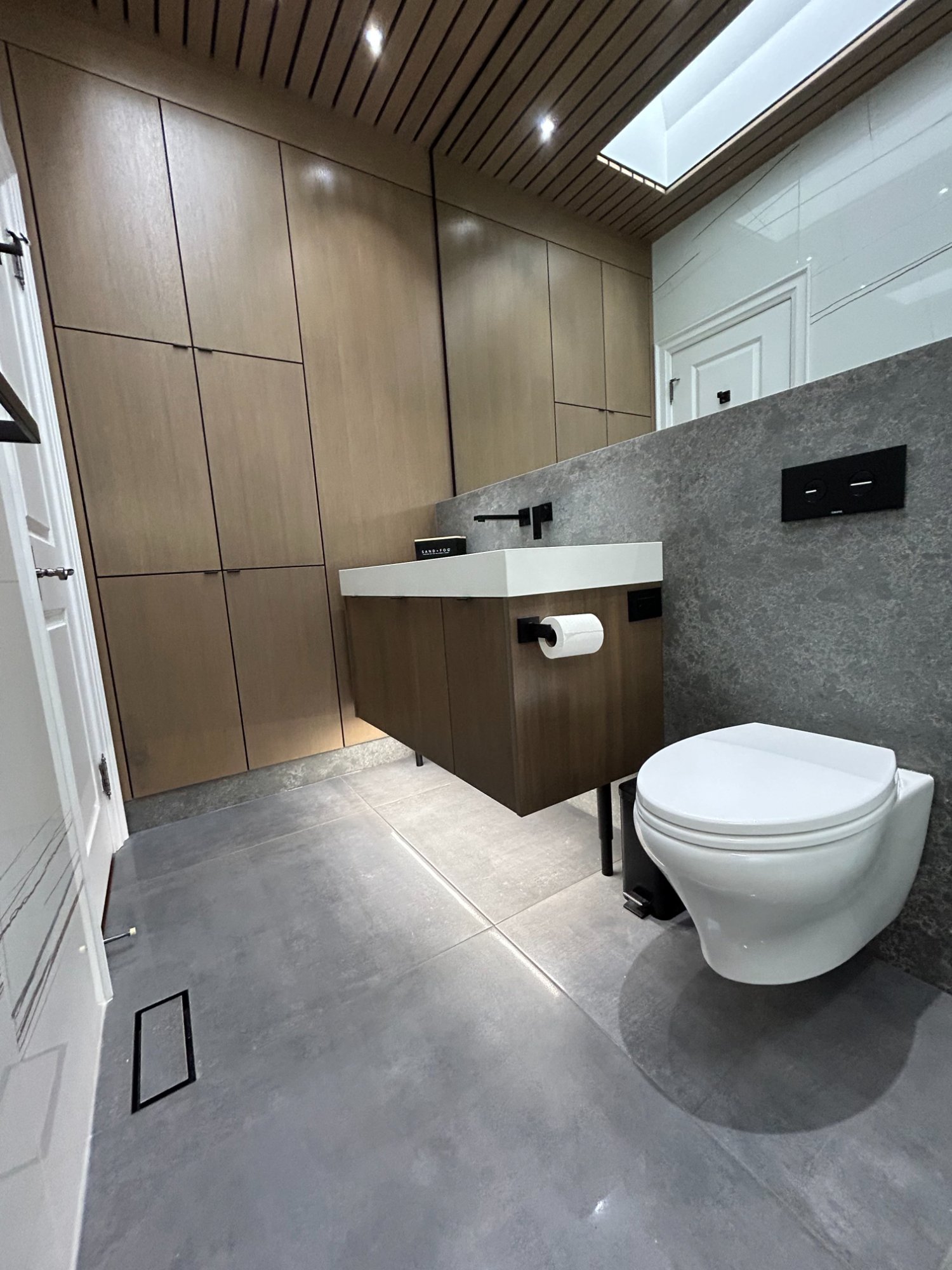 Modern bathroom with wood paneling and stone tile