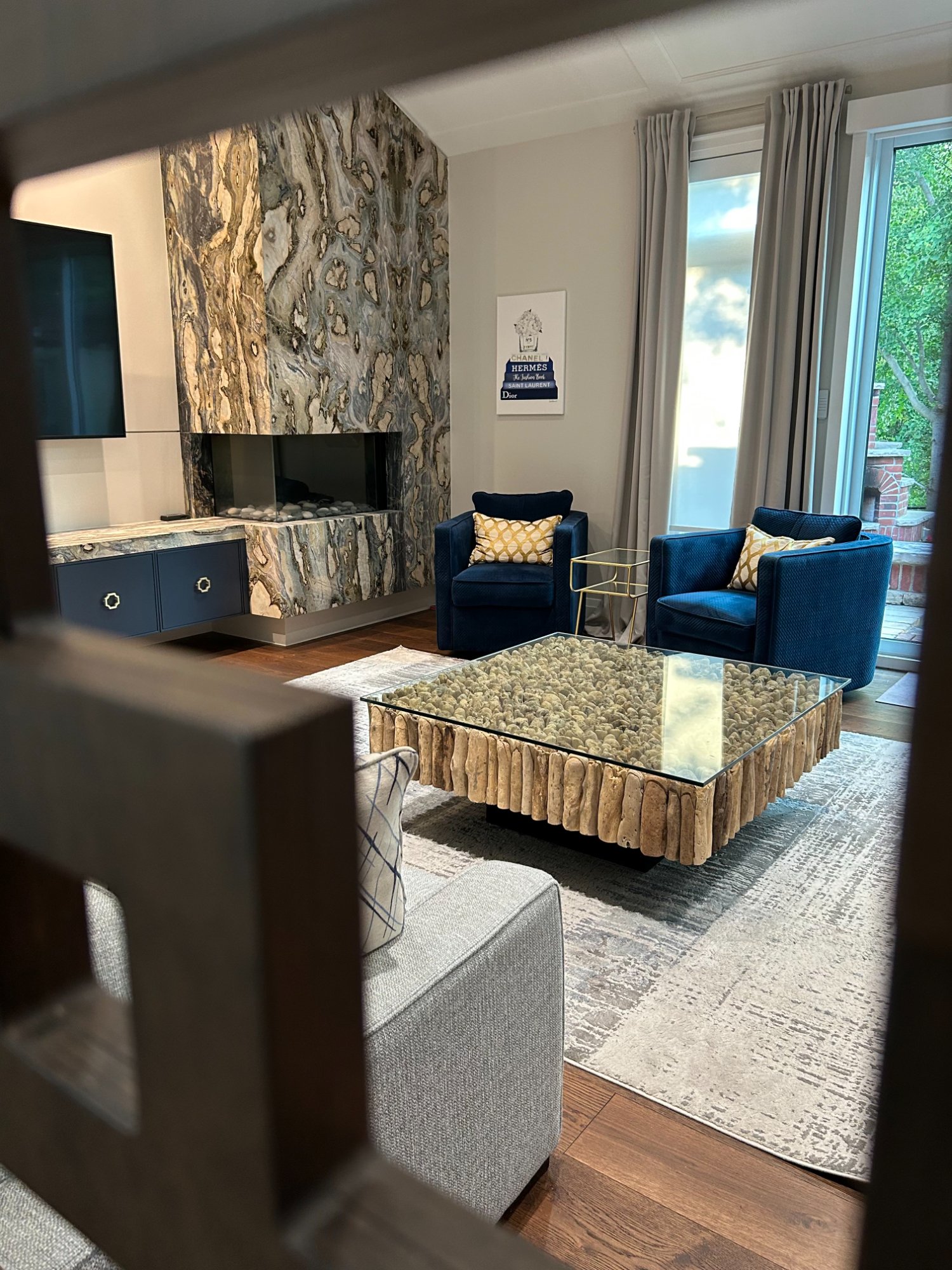 Living room with marble fireplace and custom millwork