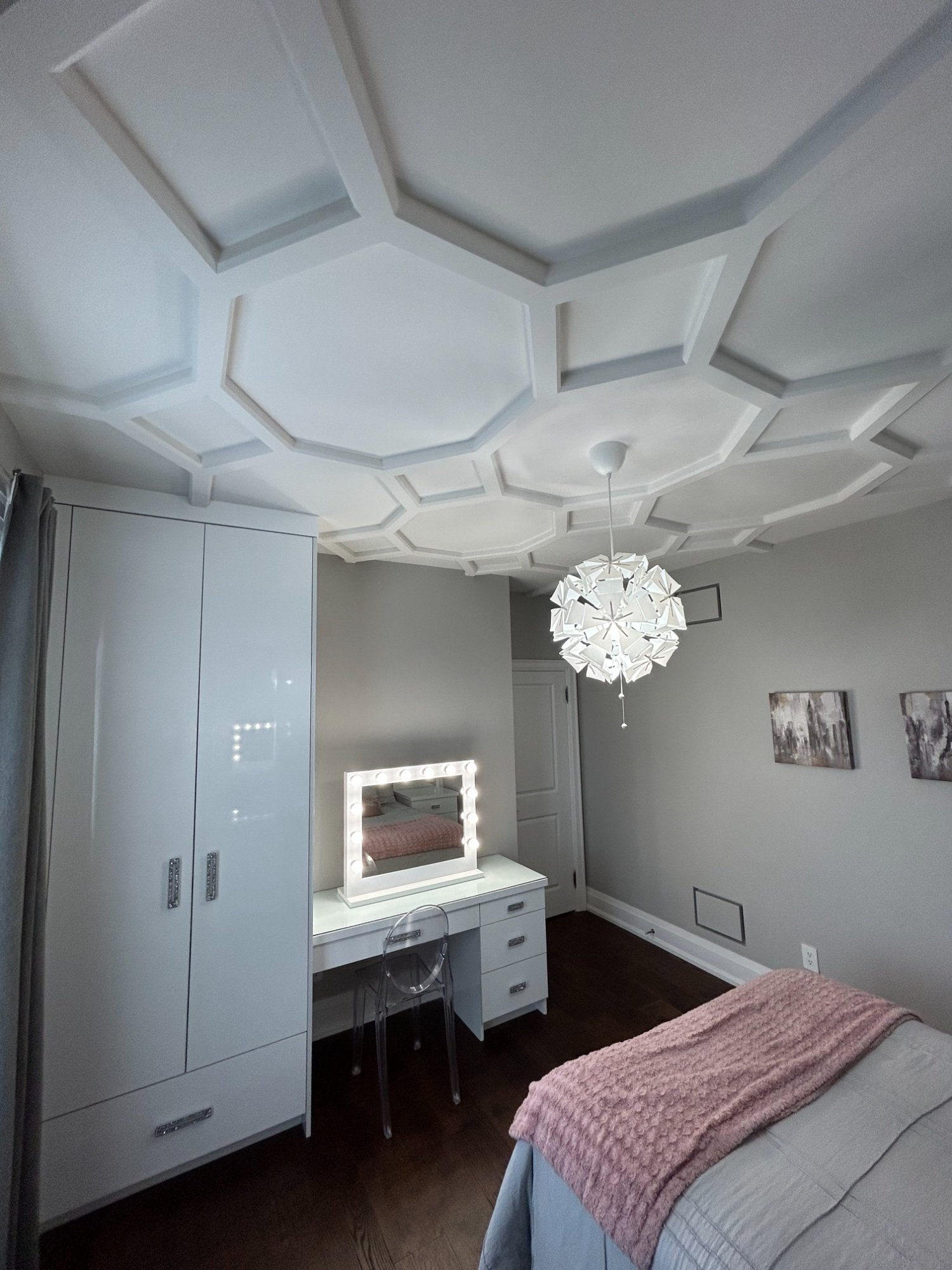 Bedroom with custom ceiling moulding and built-in cabinetry