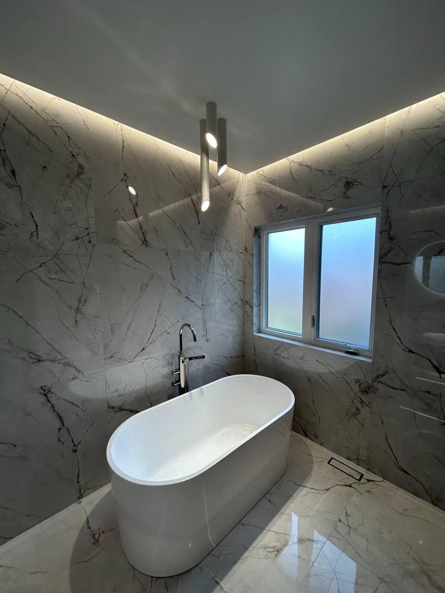 Spa-like marble bathroom with freestanding tub