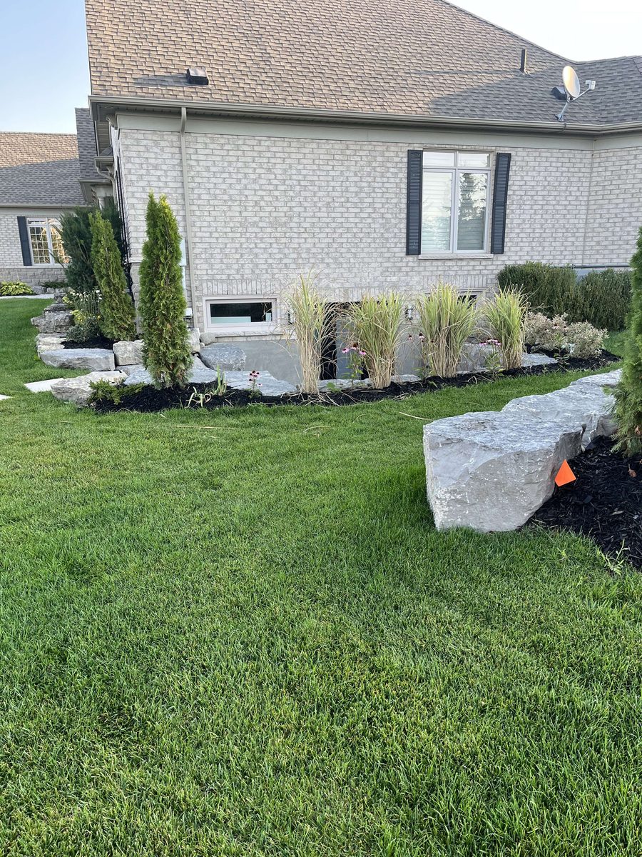 Boulder retaining wall and landscape restoration
