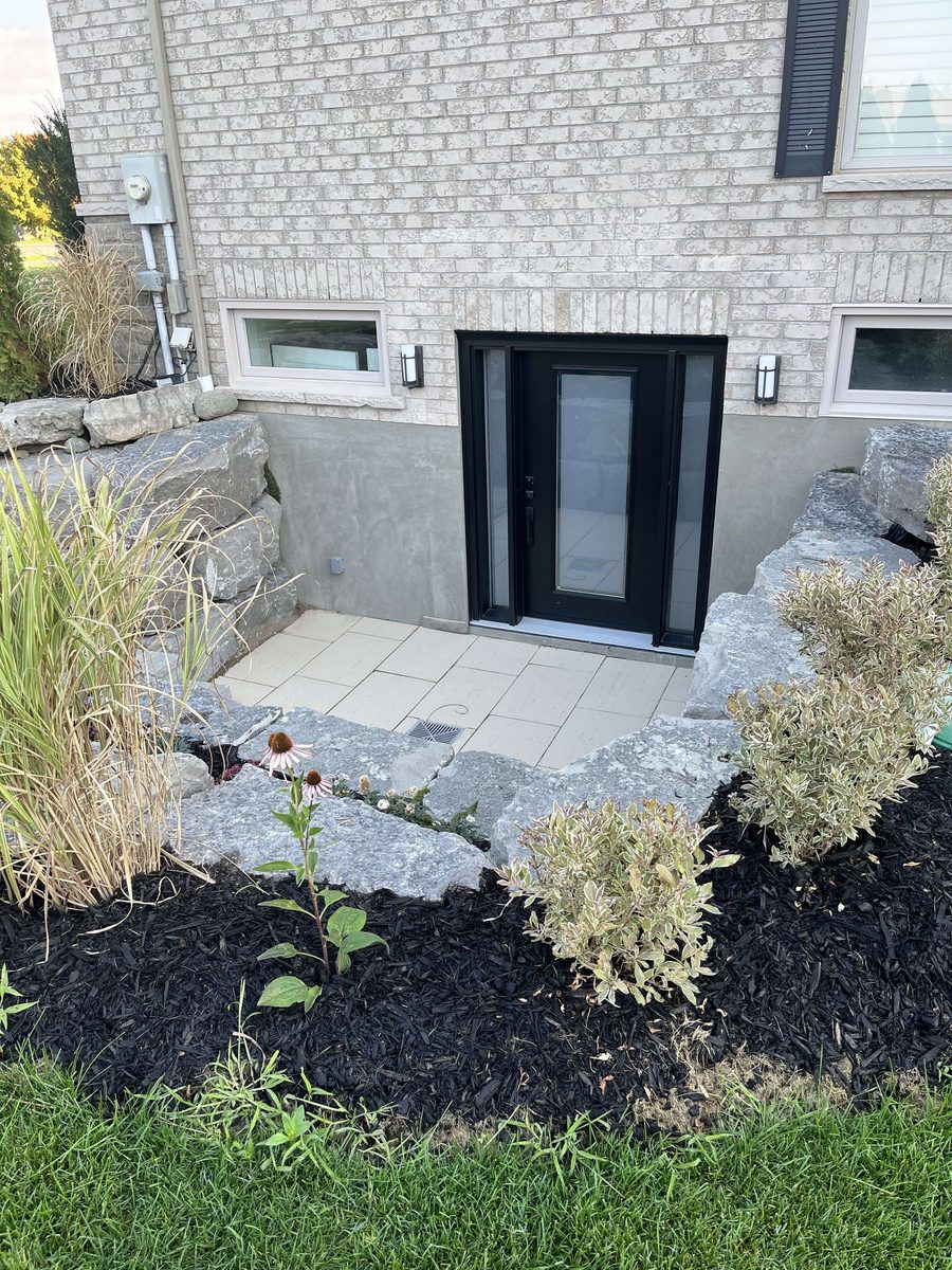 Basement walkout with stone retaining wall
