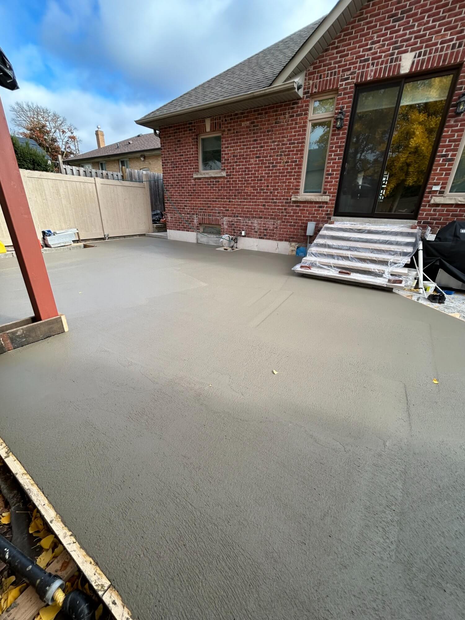 Fresh concrete patio pour adjacent to house